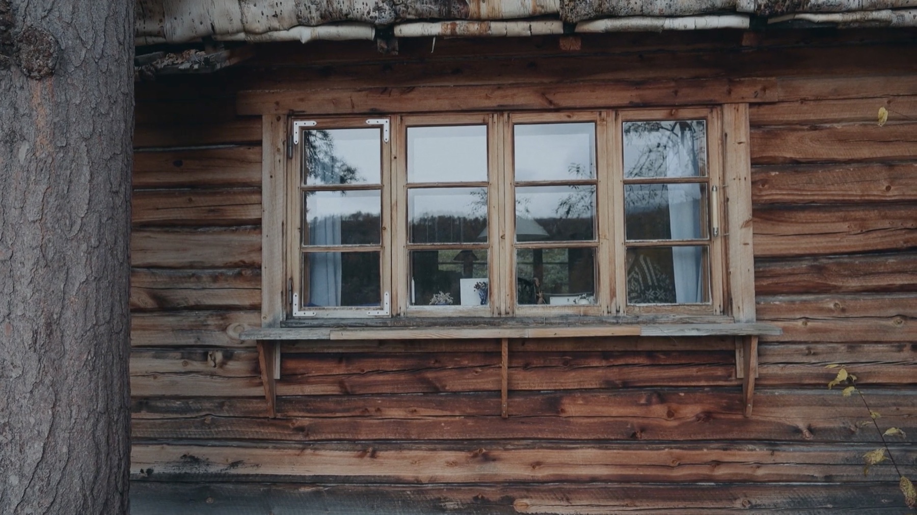 A multi-pane window in the timber wall of Kajsa Zetterquist’s home on Saltfjellet